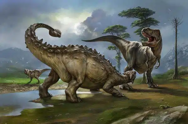  Artistic depiction of G. quayi confronting a large herbivorous dinosaur in a prehistoric landscape. The scene captures the intense interaction between the carnivorous G. quayi and its prey, with detailed environmental elements including a water body, trees, and distant mountains. G. quayi, a large theropod from the Late Triassic period, is shown in an aggressive stance, emphasizing its role as a formidable predator in what is now North America.